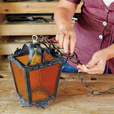 thread the cord and ground wire through the chain to rewire an all-weather lantern