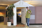 Mark Powers with a margarita outside his cubicle