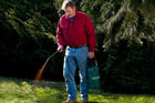 Roger Cook spraying compost tea to fertilize a lawn