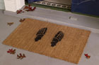a skeleton-feet stenciled doormat