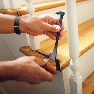 removing the end cap on a stairway with a flat pry bar