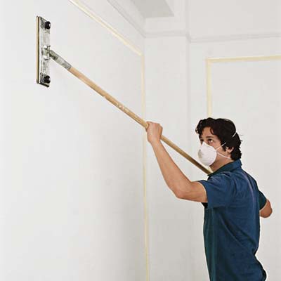 man clearing dust from teh walls