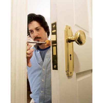 Hanging the door and attaching the hardware.