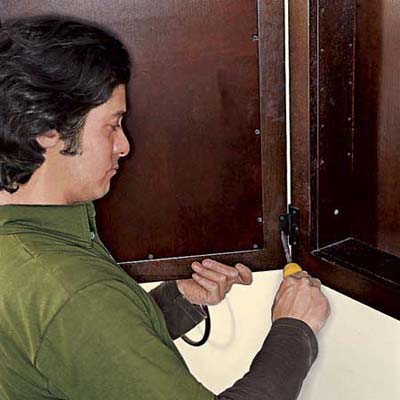 Reattach the cabinet door making sure not to bend the 
hinges