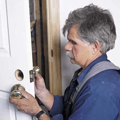 Tom Silva mounting the latch hardware of a prehung door