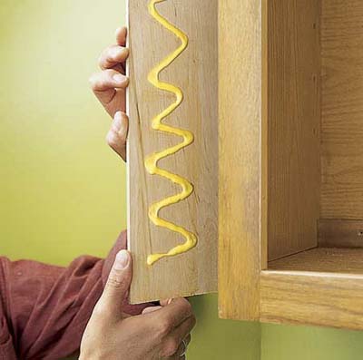 Covering exposed sides of cabinet, using plywood and glue. < > Covering exposed sides of cabinet, using plywood and glue. < >