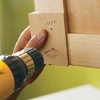 Attach knobs and pulls and finish the drawers