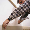 Nail baseboard to wall