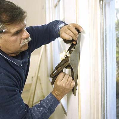 Tom Silva trimming out a window