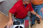general contractor tom silva demonstrating installation of a whole house fan
