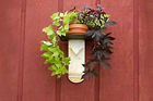 marble fireplace mantel fragment turned into a pedestal shelf for an outdoor plant