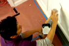 man painting wainscoting white