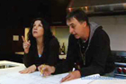 This Old House editor, Alexandra Bandon and contractor in the kitchen with floor plans