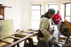 workers in a room with table miter saw