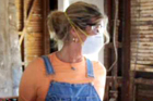woman with overalls and a dust mask