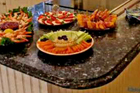 granite countertop covered with plates of hors d'oeuvres