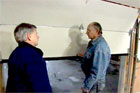 Tom Silva and homeowner assembling and hanging a new garage door