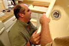 Richard Trethewey installing a kitchen sink