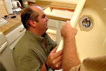 Richard Trethewey installing a kitchen sink
