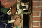 a hose attaching to a pipe to drain it for winter