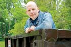 this old house editor Scott Omelianuk standing in a dumpster