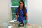 Jennifer Stimpson with paint and various painting tools and materials