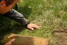 Roger Cook patches a damaged lawn