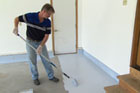 Doug Fasching coats a garage floor with epoxy