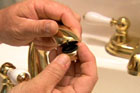 Richard Trethewey cleans a faucet aerator