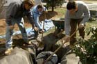 Roger Cook installs a drywell to collect water from a basement sump pump
