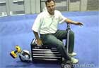 Man sitting on drill-powered bike