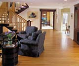 Adding a second story meant extensive changes to the first floor as well. This view is from the front door through the living room into the relocated kitchen.