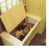 A heating vent does double duty in this window seat, which conceals a slatted shelf that's just right for drying wet socks and gloves out of sight.