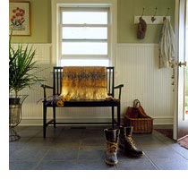 This front entry extends a warm welcome while providing such basics as comfortable seating, cap and coat hooks, a fiber doormat and a stash basket. Stylish and sturdy wainscoting reaches midway up the walls.