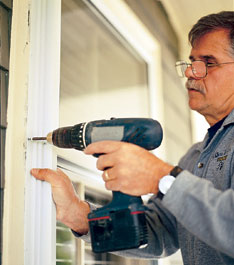 screwing the storm window's edges