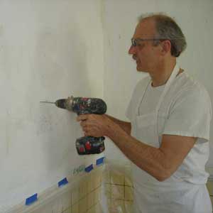 drill through the plaster on both sides of the crack