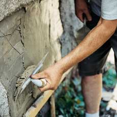 using a finishing trowel on second coat of stucco