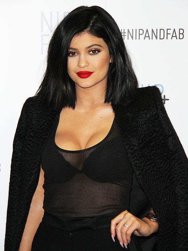 Kylie Jenner poses for a late night selfie in skintight PVC trousers and a  fringed crop top